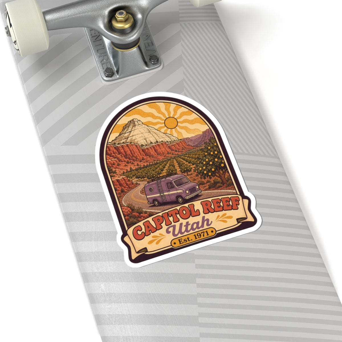 Die-cut sticker on striped notebook, retro camper van in canyon with CAPITOL REEF Utah Est. 1971