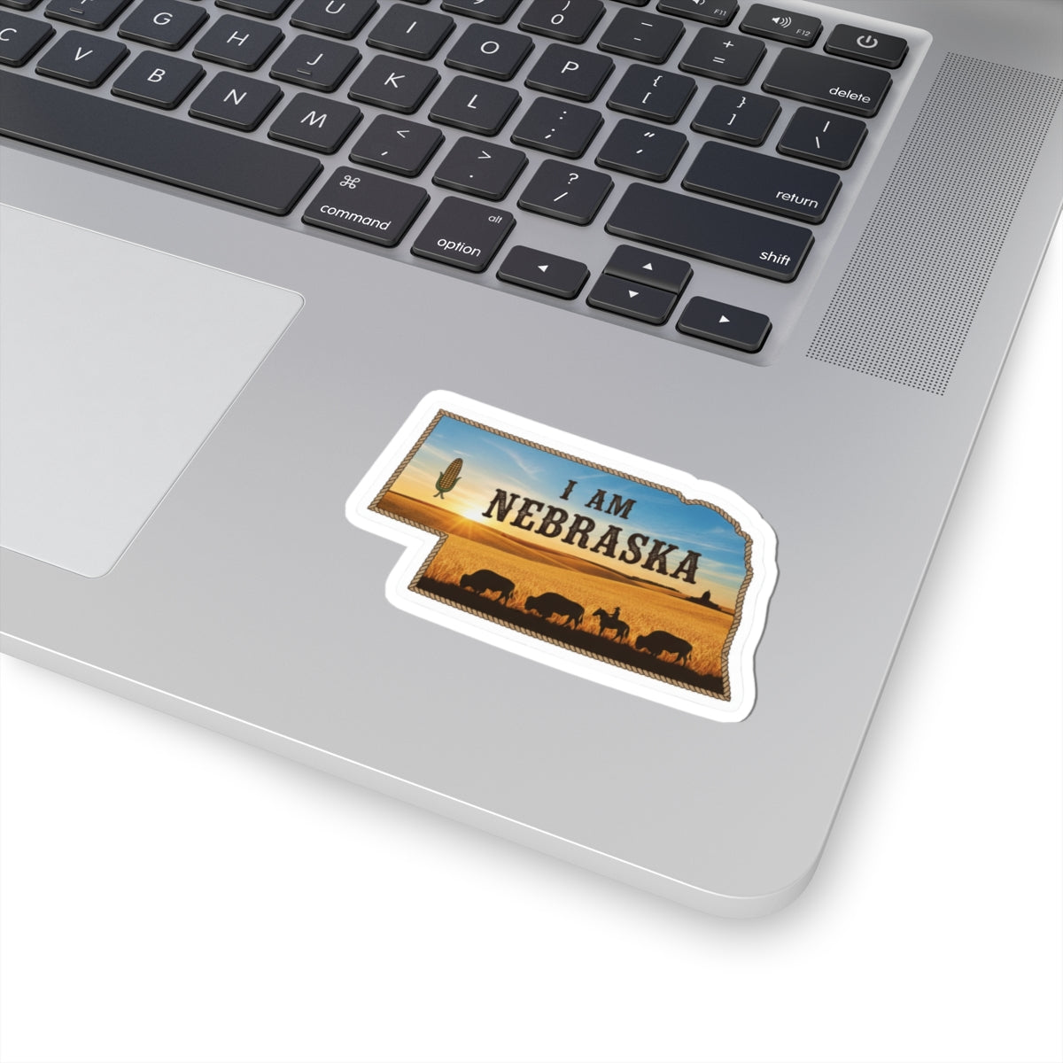 I AM NEBRASKA die-cut sticker, white border, small landscape with animals and text