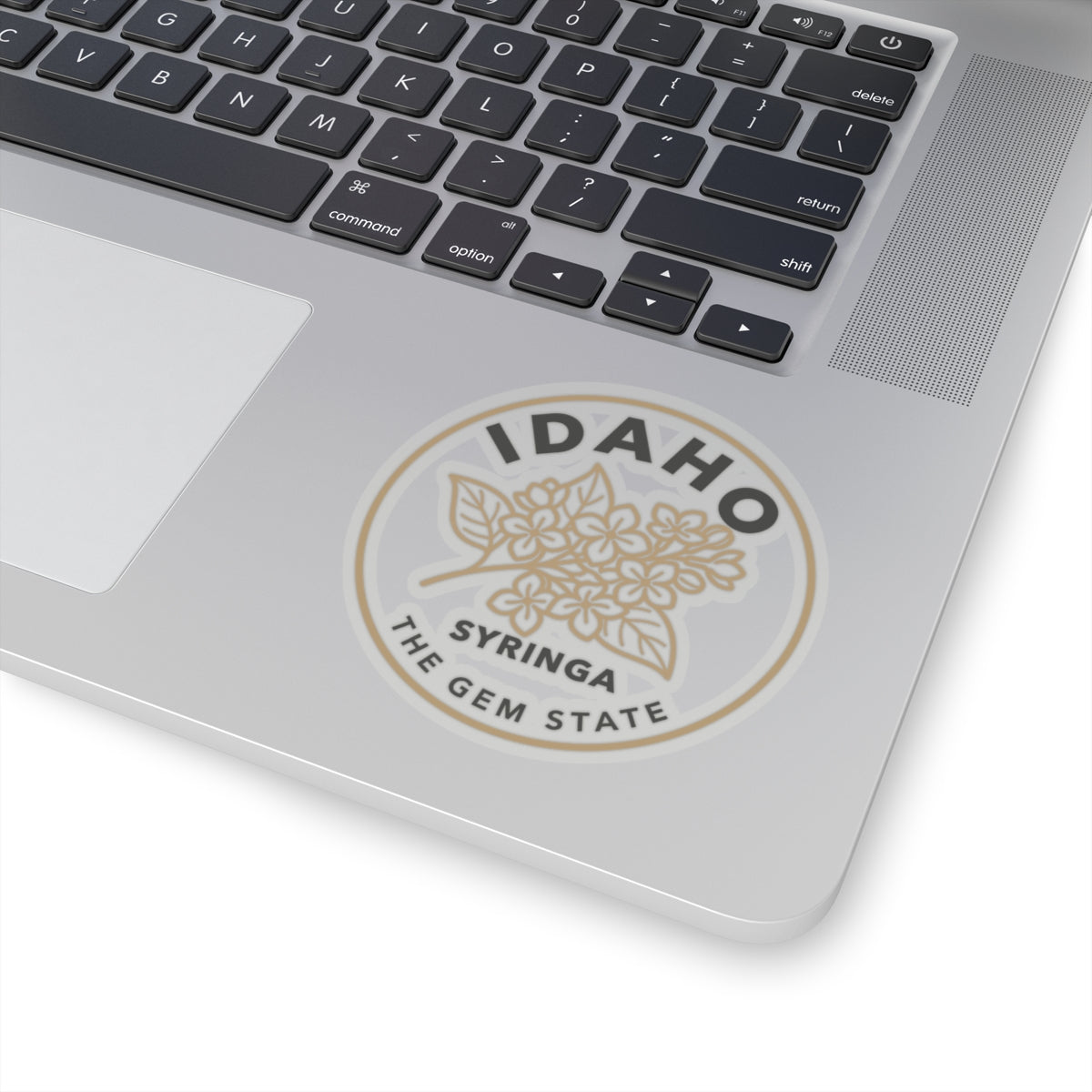 Transparent vinyl sticker on laptop surface: Idaho syringa flower emblem