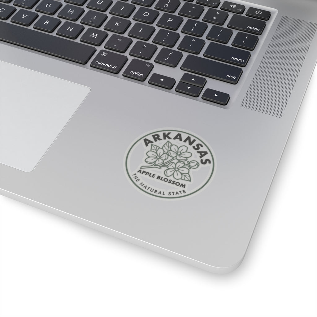 Arkansas apple blossom sticker applied to a laptop trackpad area with “THE NATURAL STATE” ring.