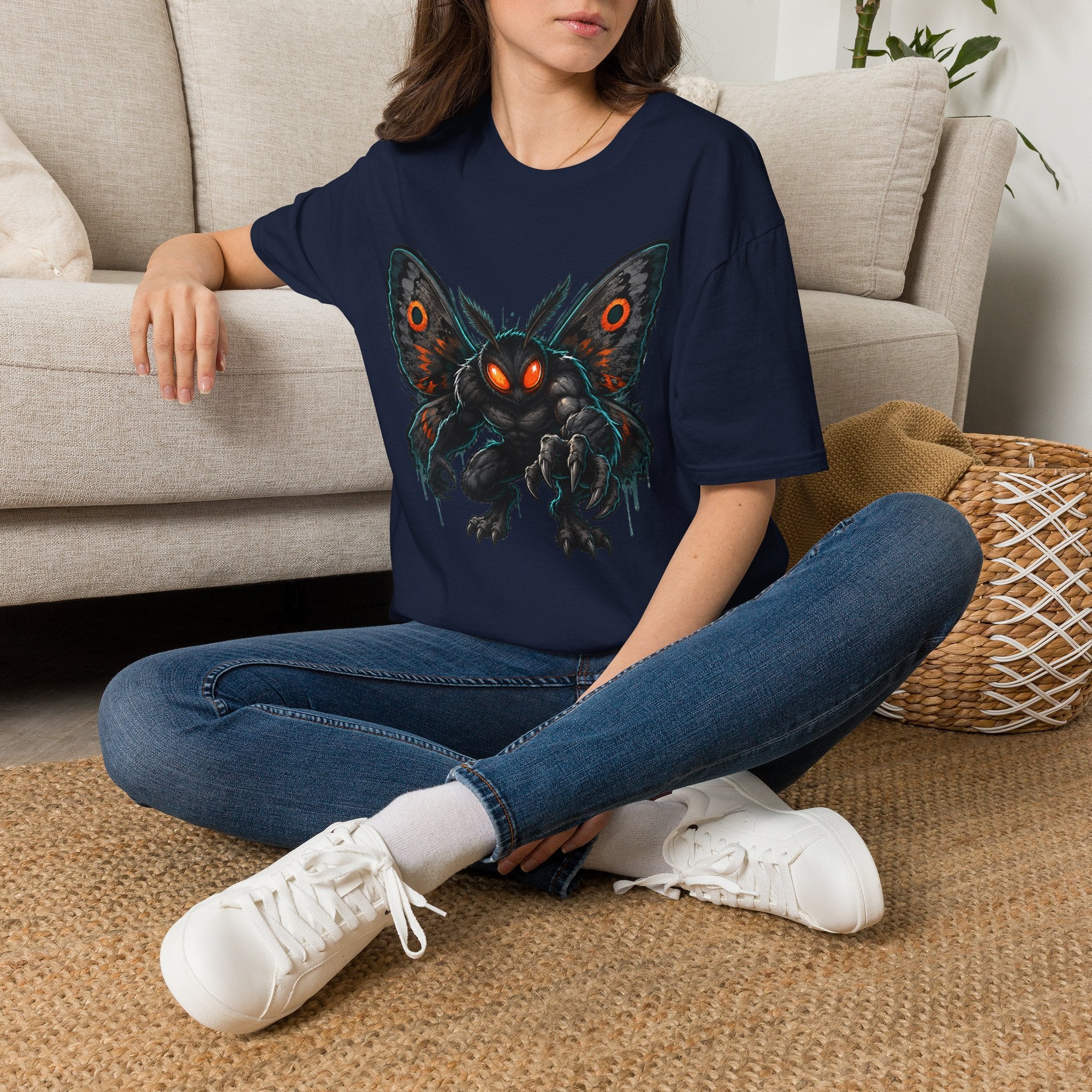 Navy monster moth graphic T-shirt with glowing eyes, worn on model