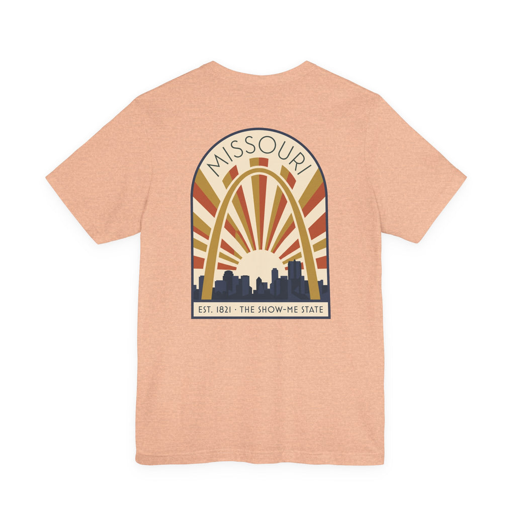 Peach Missouri sunrise art deco T-shirt with arch skyline graphic and “MISSOURI” text.