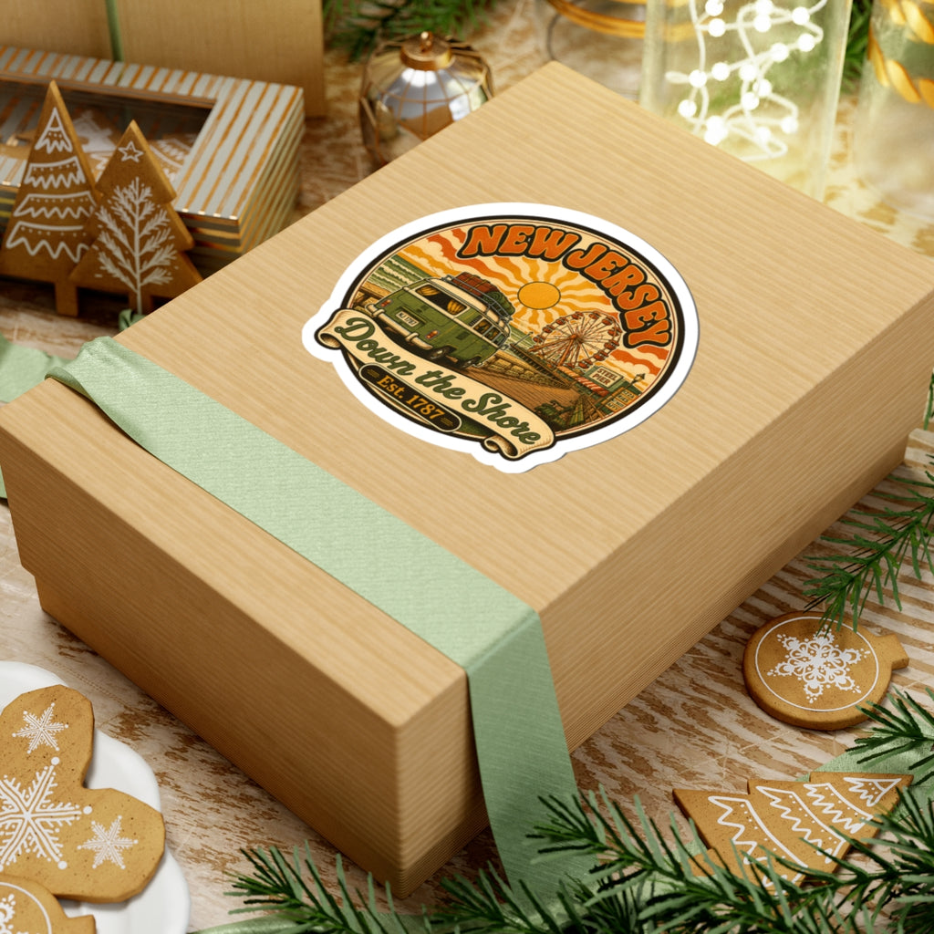 Round sticker on a gift box top, New Jersey beach scene with van and ferris wheel.