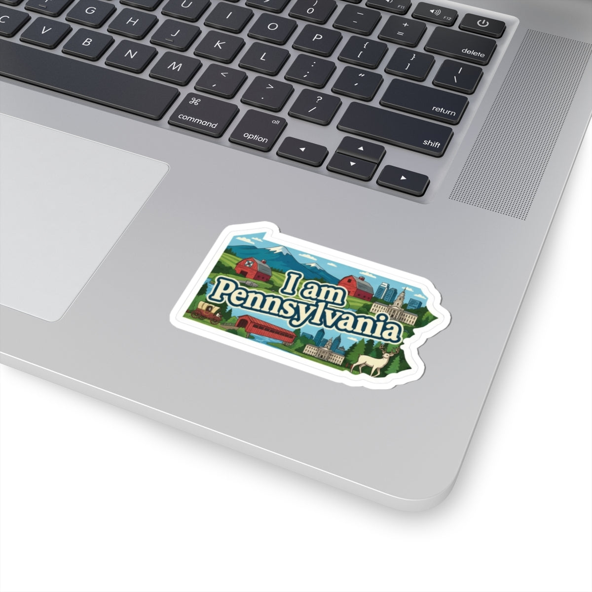 I am Pennsylvania sticker on a laptop keyboard, colorful skyline and “Pennsylvania” text