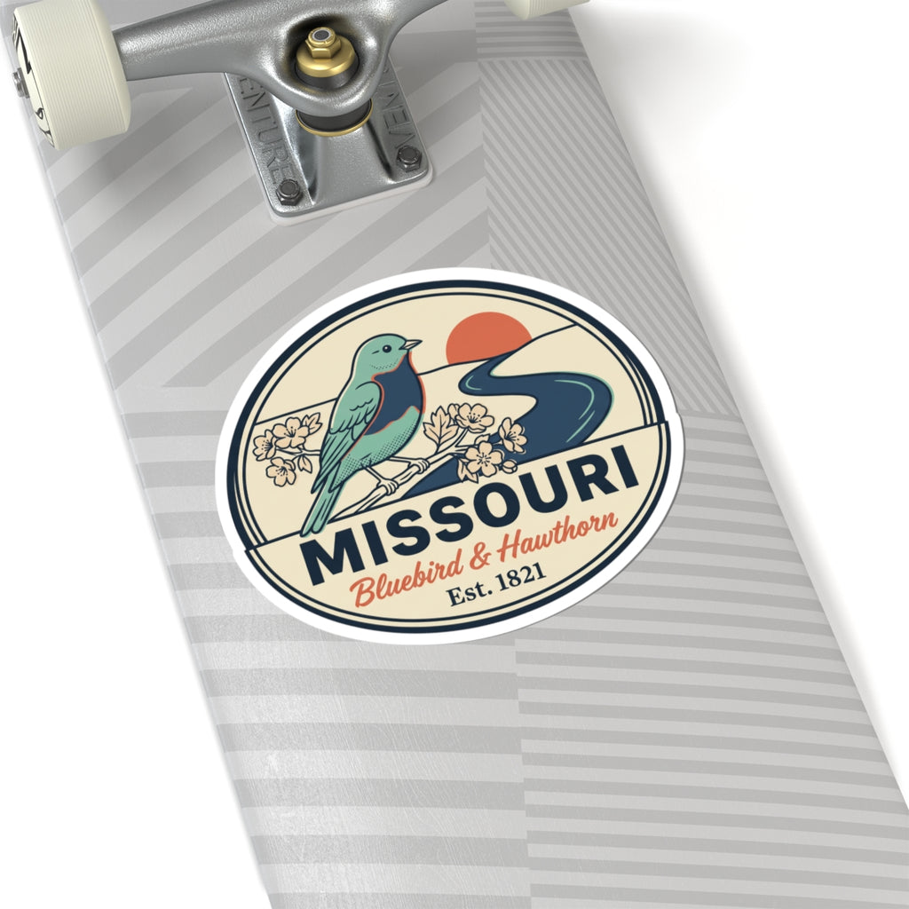 Round Missouri state badge sticker with teal bluebird, flowers, and “MISSOURI” across the center