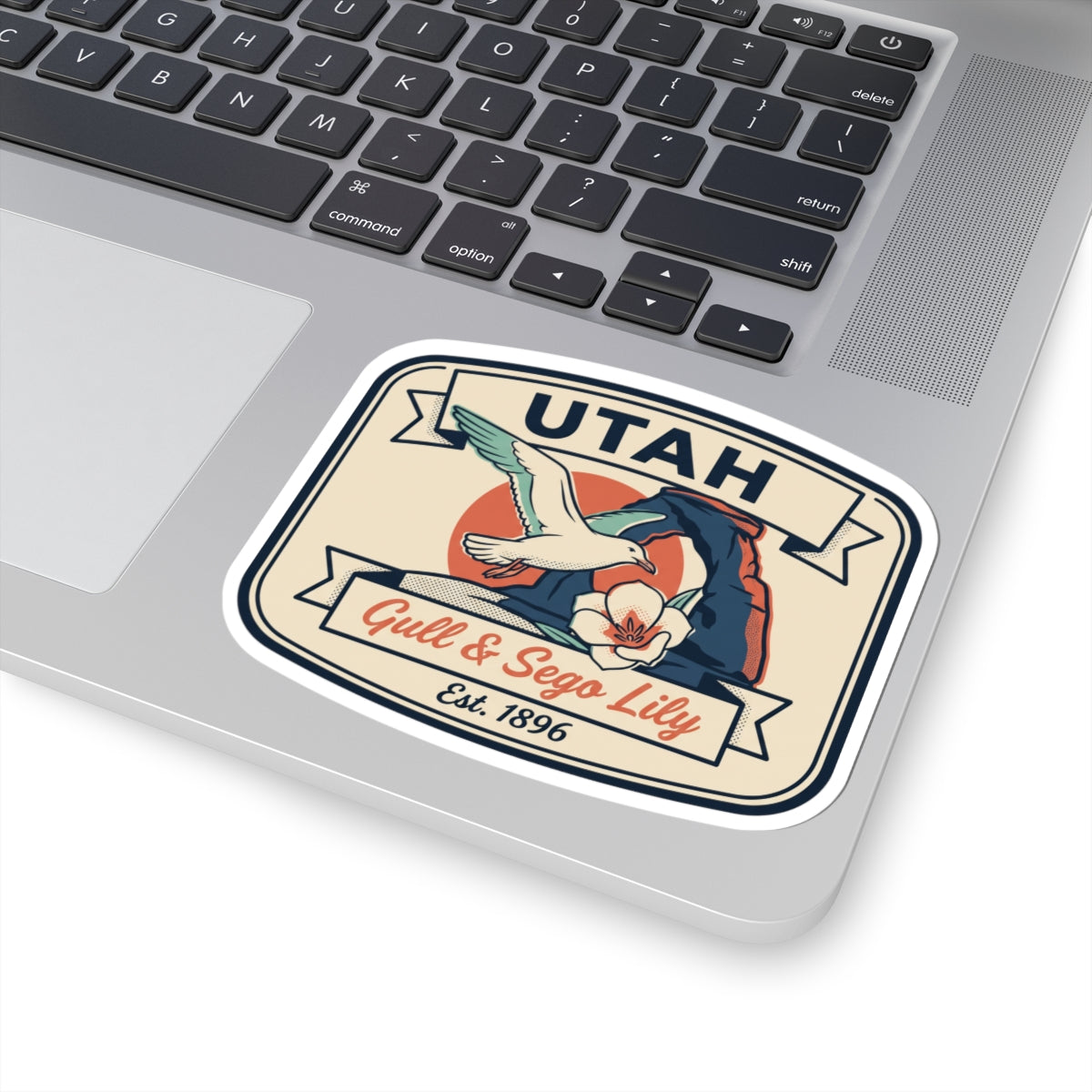 Utah sticker decal on laptop showing gull, sego lily, and “Est. 1896”