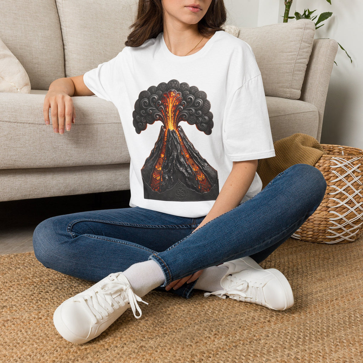 White volcano graphic T-shirt worn with blue jeans; fiery eruption with smoky clouds