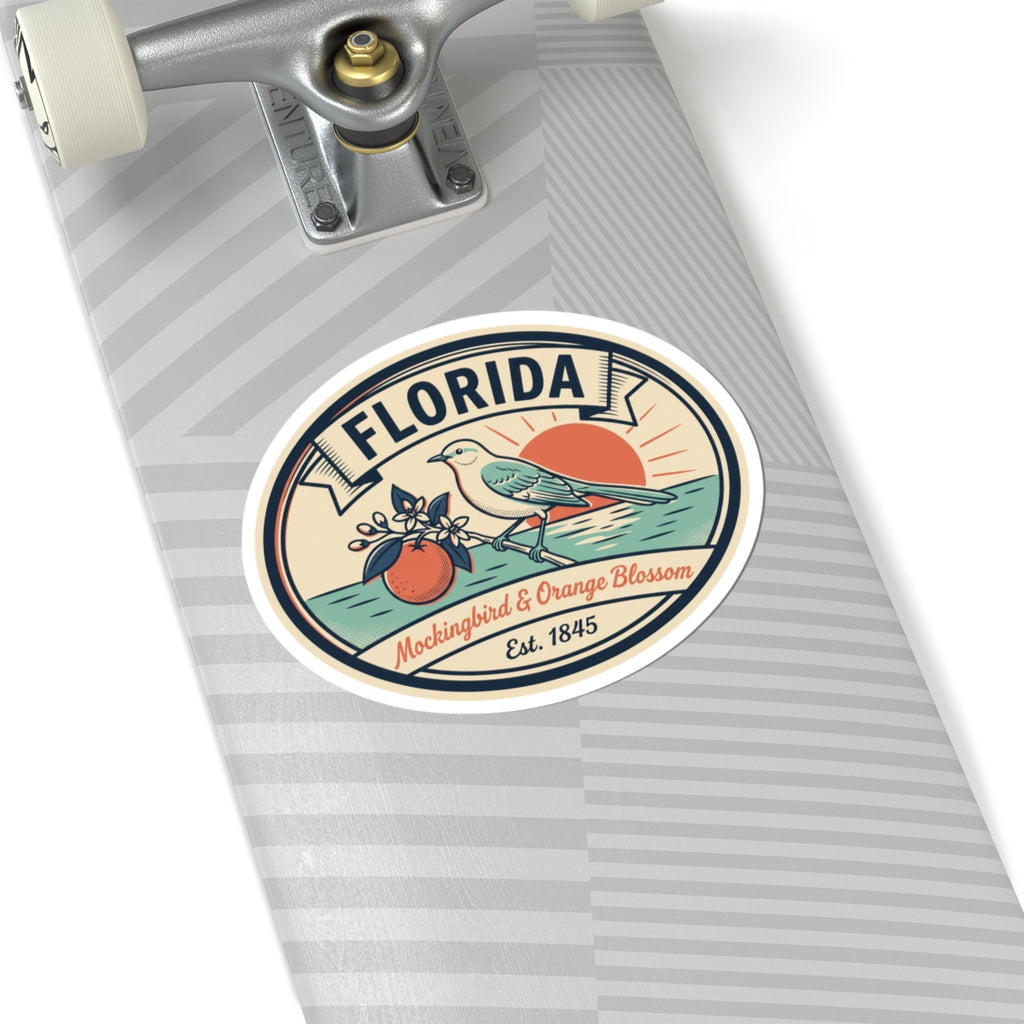 Circular Florida sticker on a striped surface, featuring mockingbird and orange blossom
