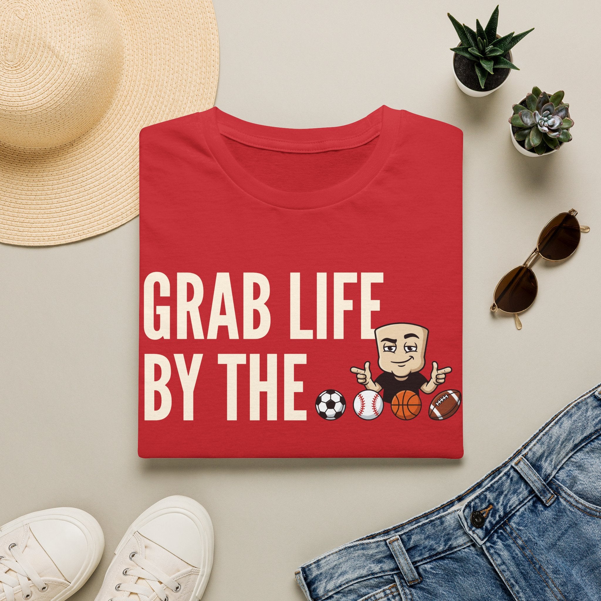 Red graphic T-shirt with motivational text and sports ball characters on the front