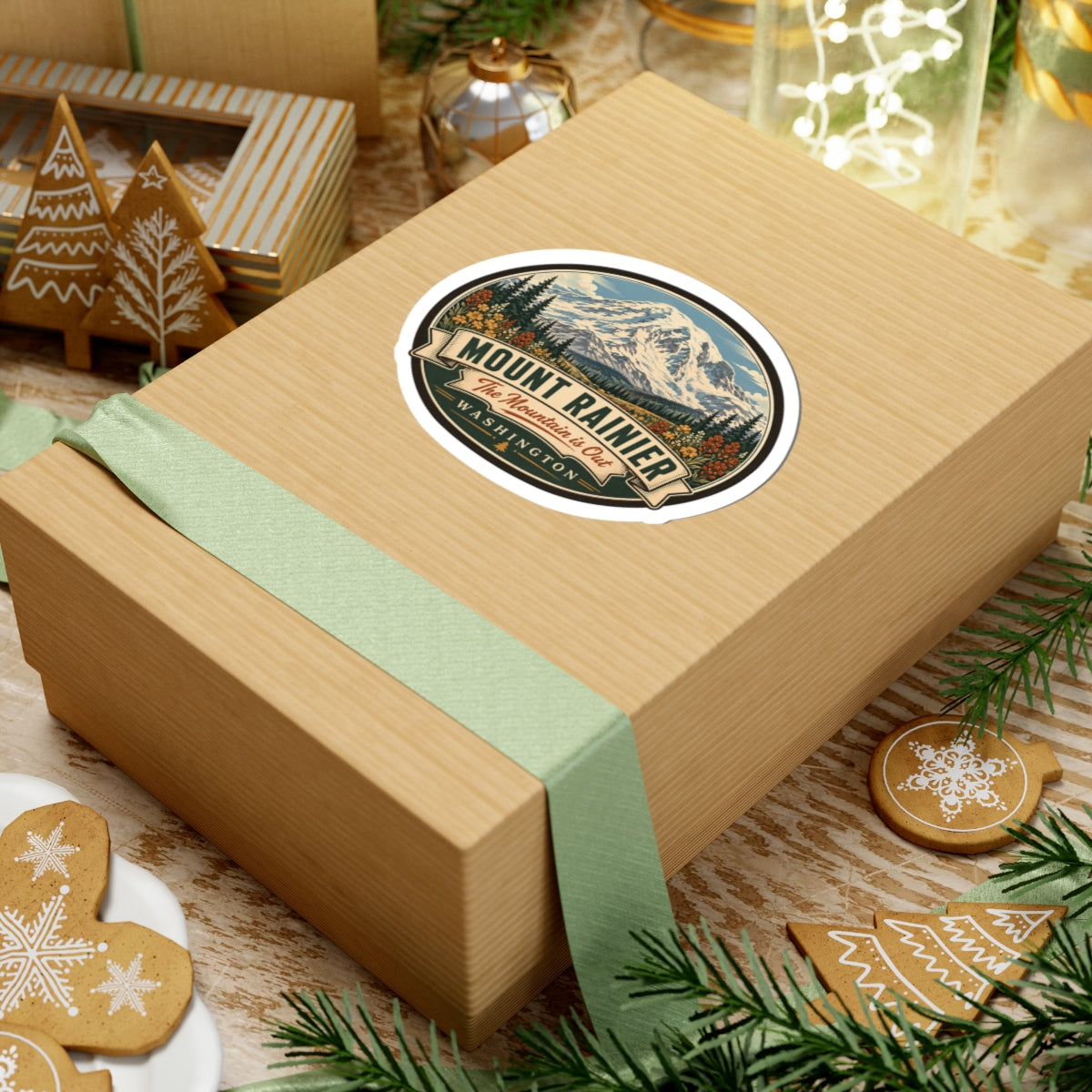 Oval Mount Rainier sticker on wrapped gift box, with mountain scene and WASHINGTON text