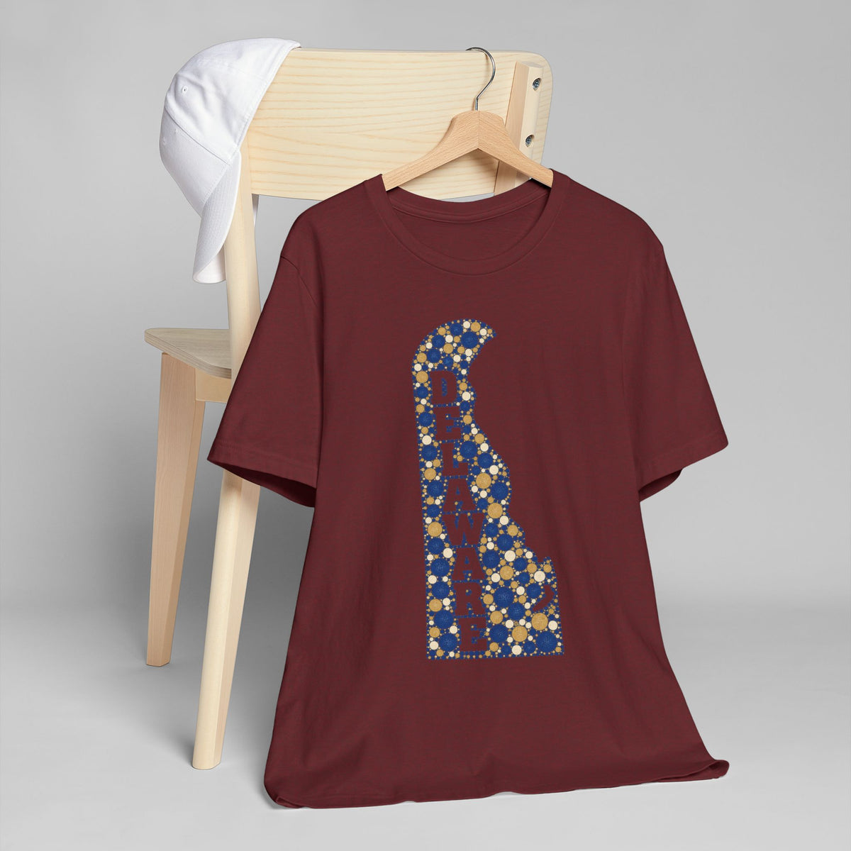 Burgundy crew-neck t-shirt featuring a blue-and-gold Delaware map graphic letter B.