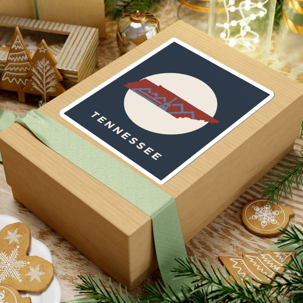 Tennessee outline sticker with retro mountains and guitar detail on a wrapped gift box