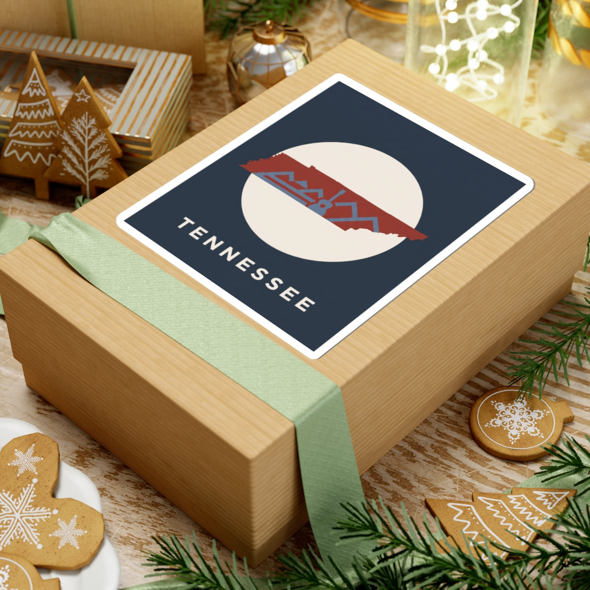 Tennessee outline sticker with retro mountains and guitar detail on a wrapped gift box