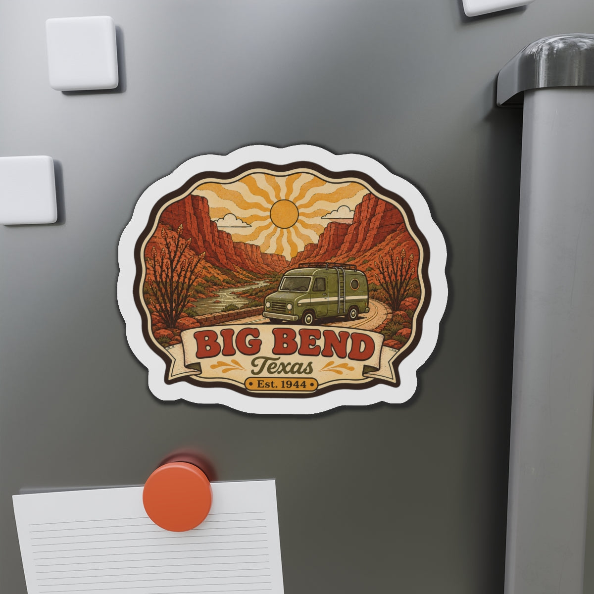 Die-cut Big Bend Texas magnet with camper van across canyon under yellow sun rays.