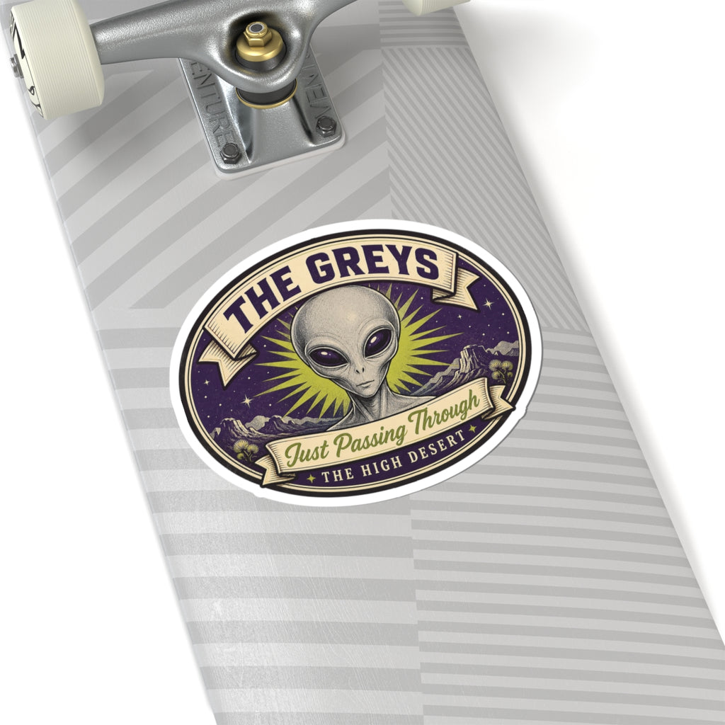 Circular sticker with gray alien face on a notebook, purple night sky and yellow rays