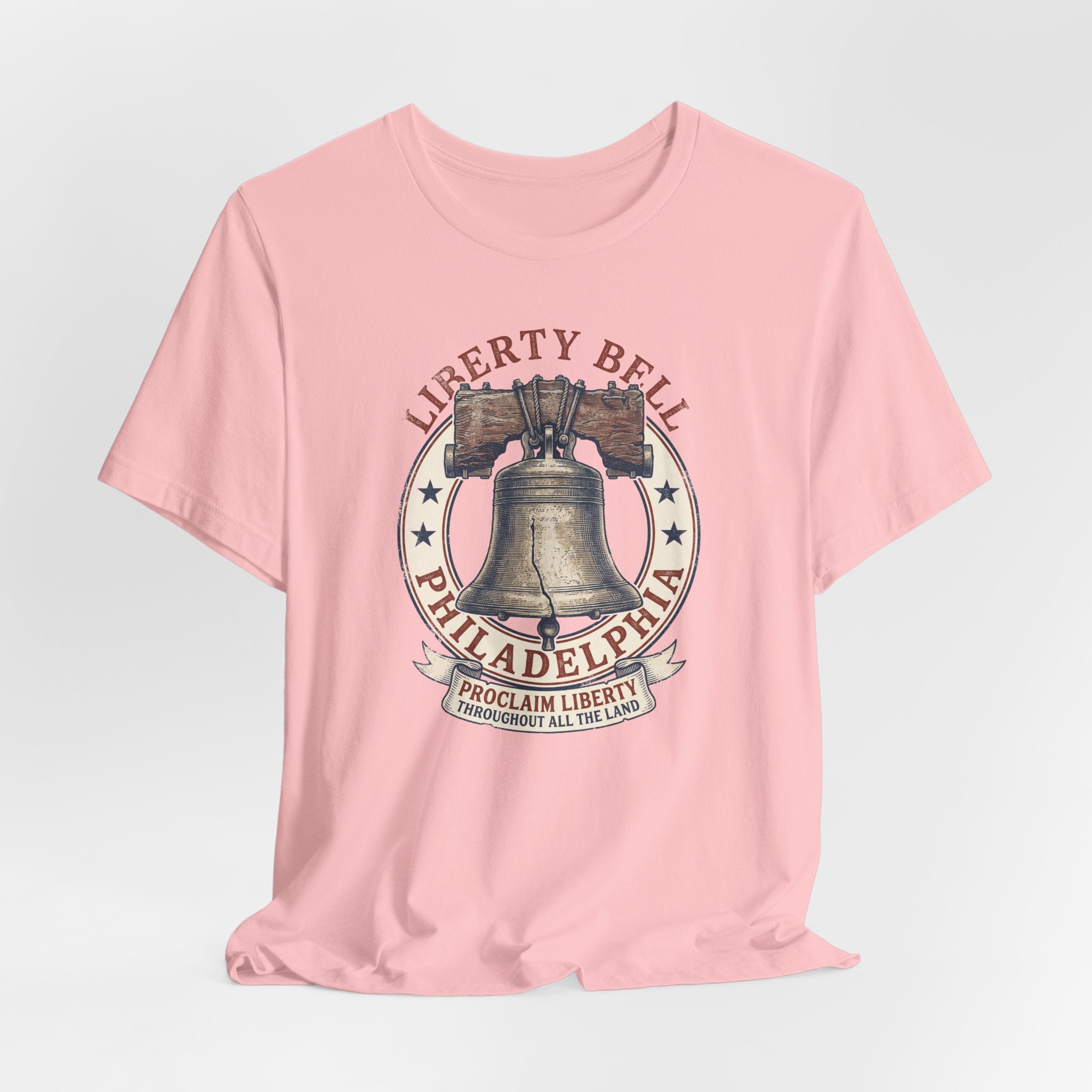 Pink crewneck T-shirt with Liberty Bell Philadelphia emblem chest print.