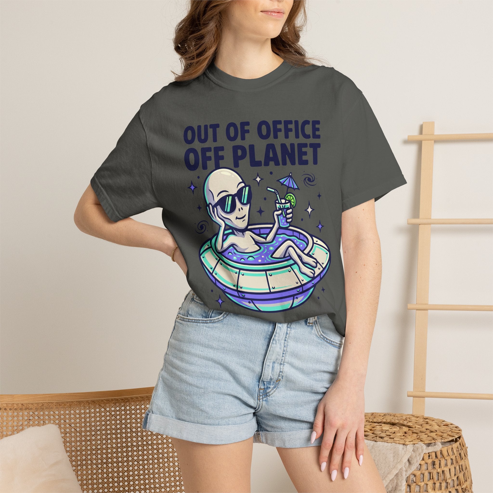 Dark gray graphic T-shirt worn by model with alien floatie illustration
