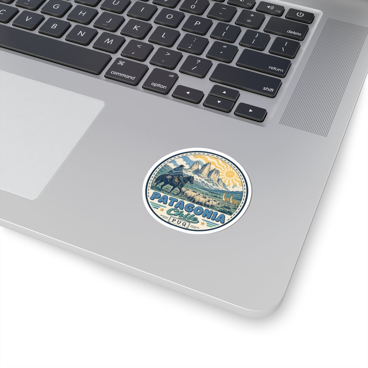 Circular Patagonia sticker with blue mountain landscape and text on a laptop