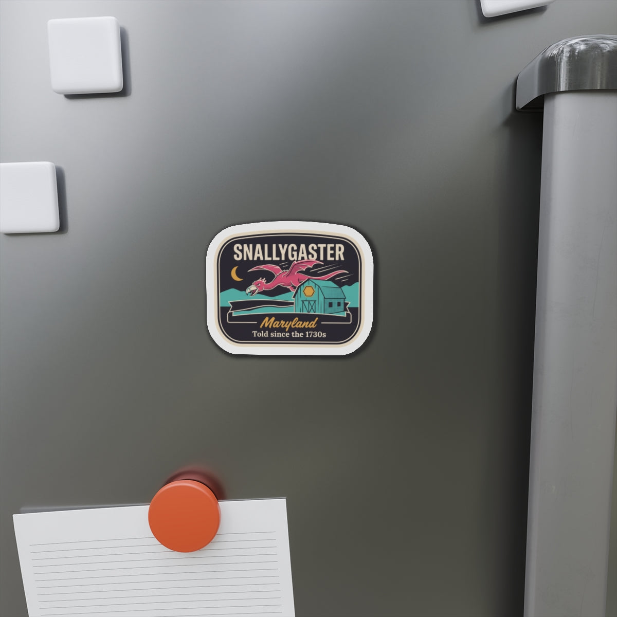 Snallygaster die-cut magnet on refrigerator door, rounded square with white rim and Maryland text.