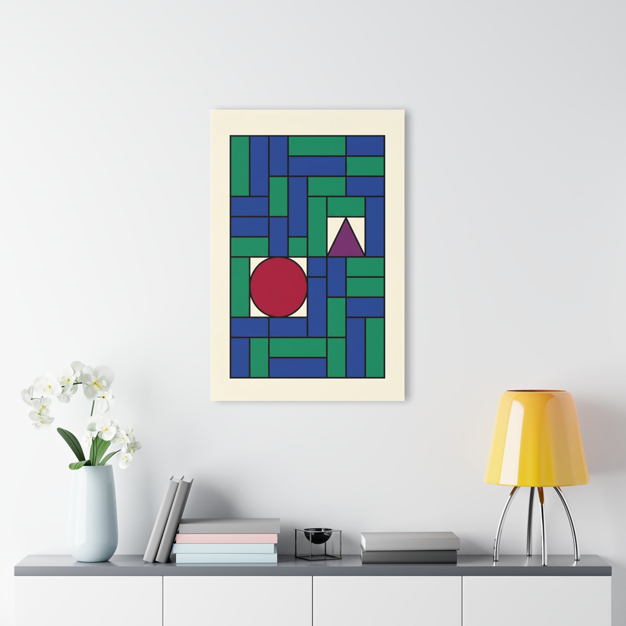 Framed geometric grid wall art with red circle, purple triangle, and blue-green interlocking blocks