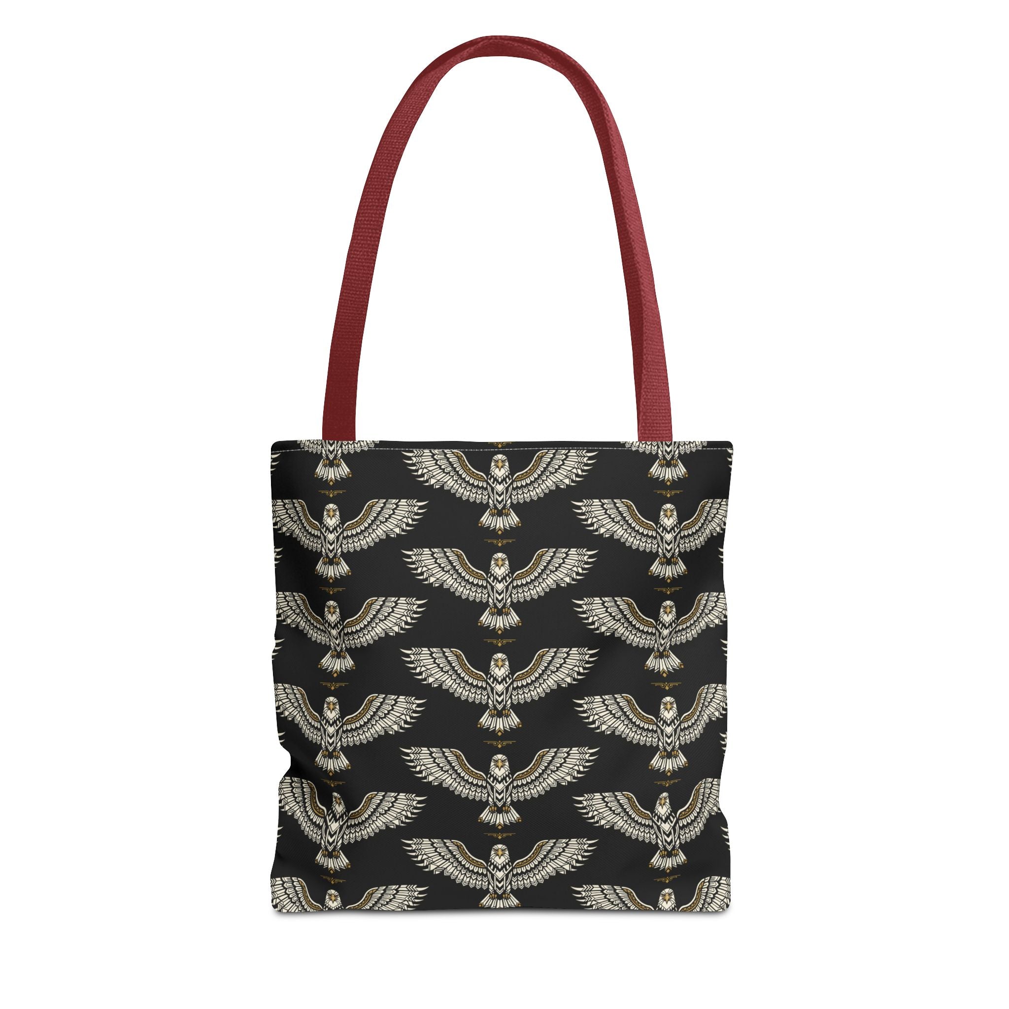 Tote bag with black fabric and repeating gold winged scarab pattern, red handles