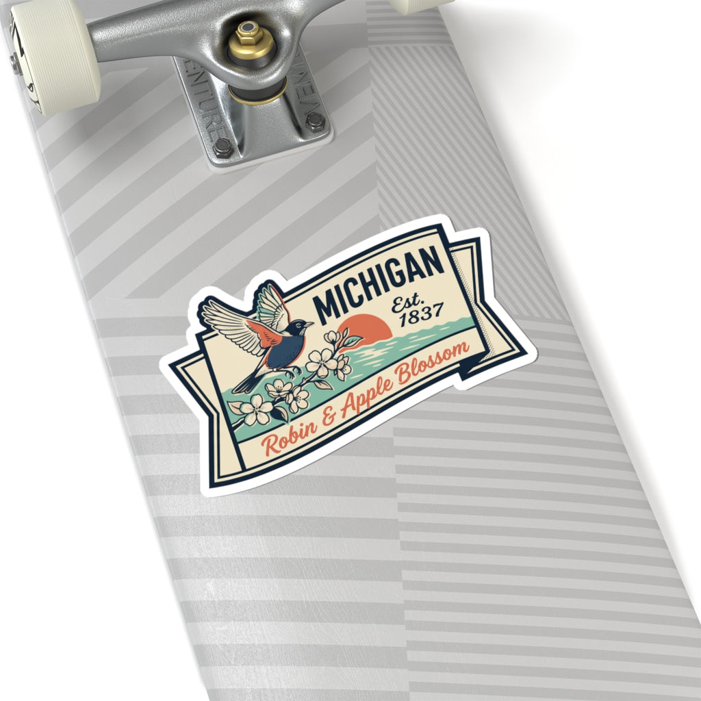 Michigan badge sticker on a striped notebook page, with robin, flowers, and “Est. 1837”