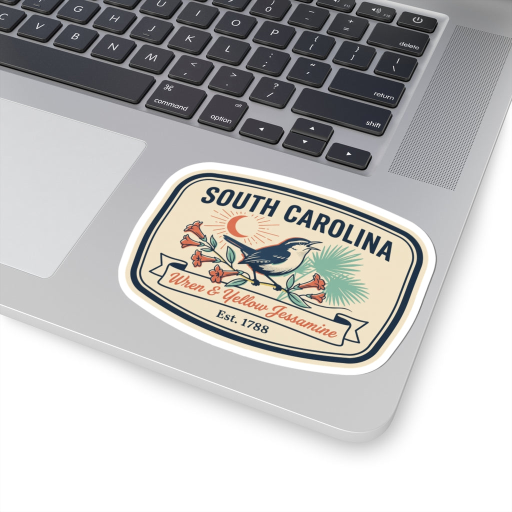 South Carolina sticker on laptop: wren and yellow jessamine crest with “SOUTH CAROLINA”