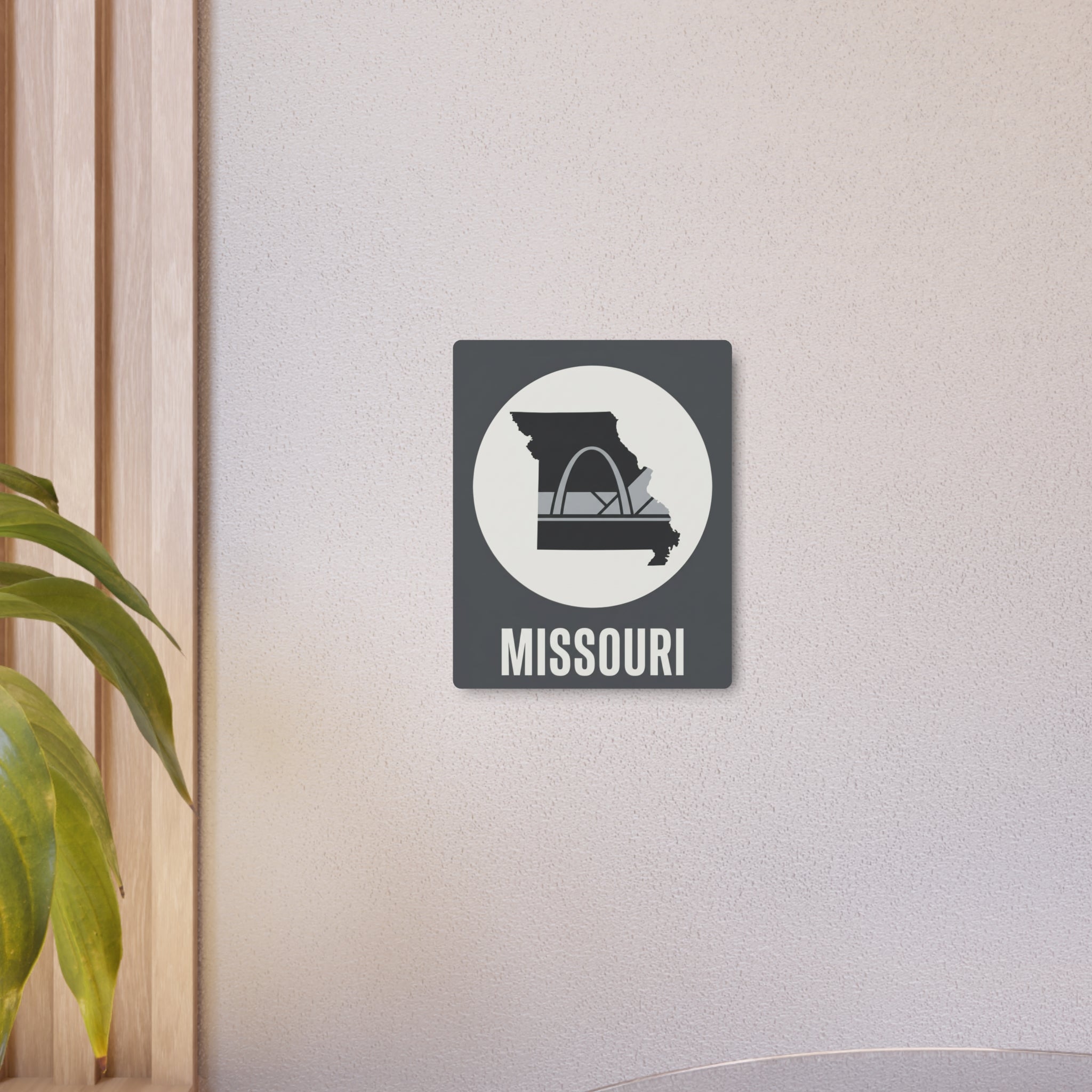 Small Missouri metal wall art sign mounted on wall with Gateway Arch icon and “MISSOURI” text.