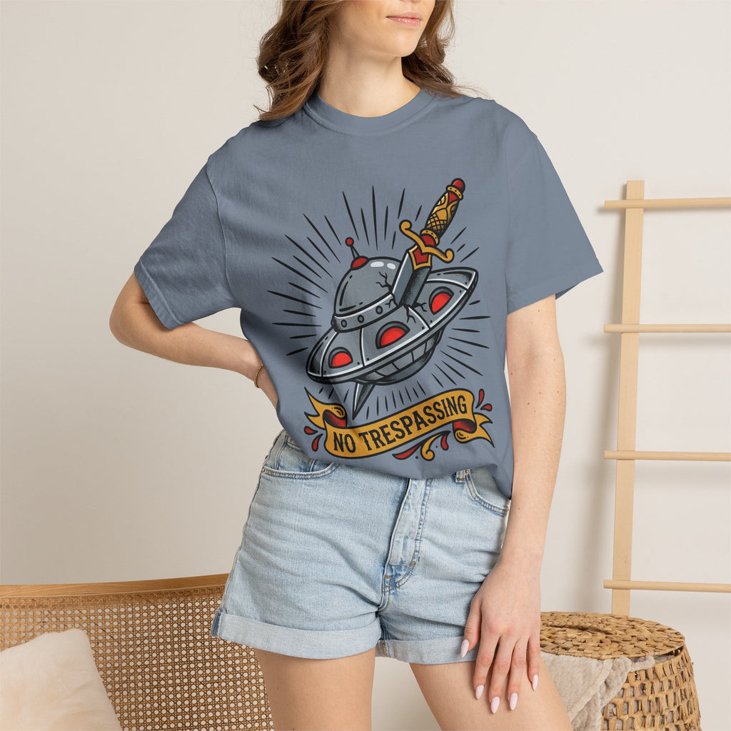 Blue graphic T-shirt with UFO and dagger “No Trespassing” print worn by model