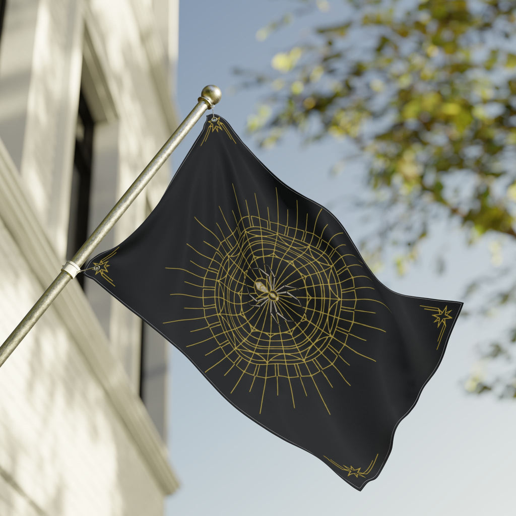 Black Halloween flag with gold spider web mandala, draped from a metal outdoor pole