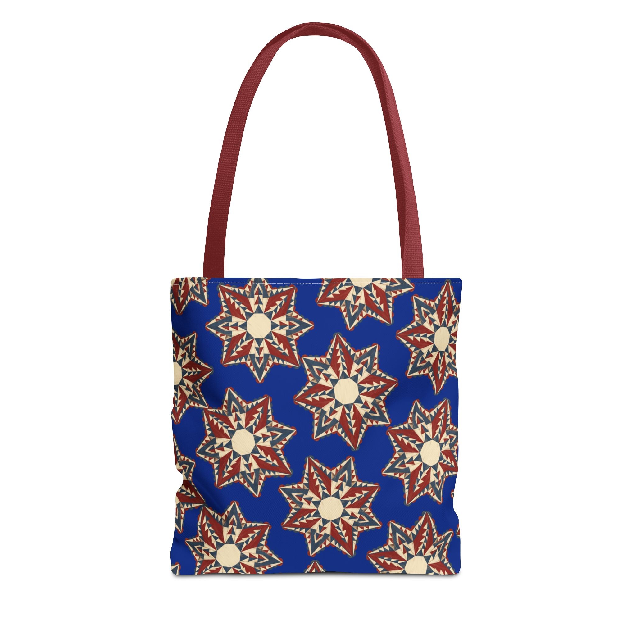 Blue tote bag with starburst floral pattern and red handles