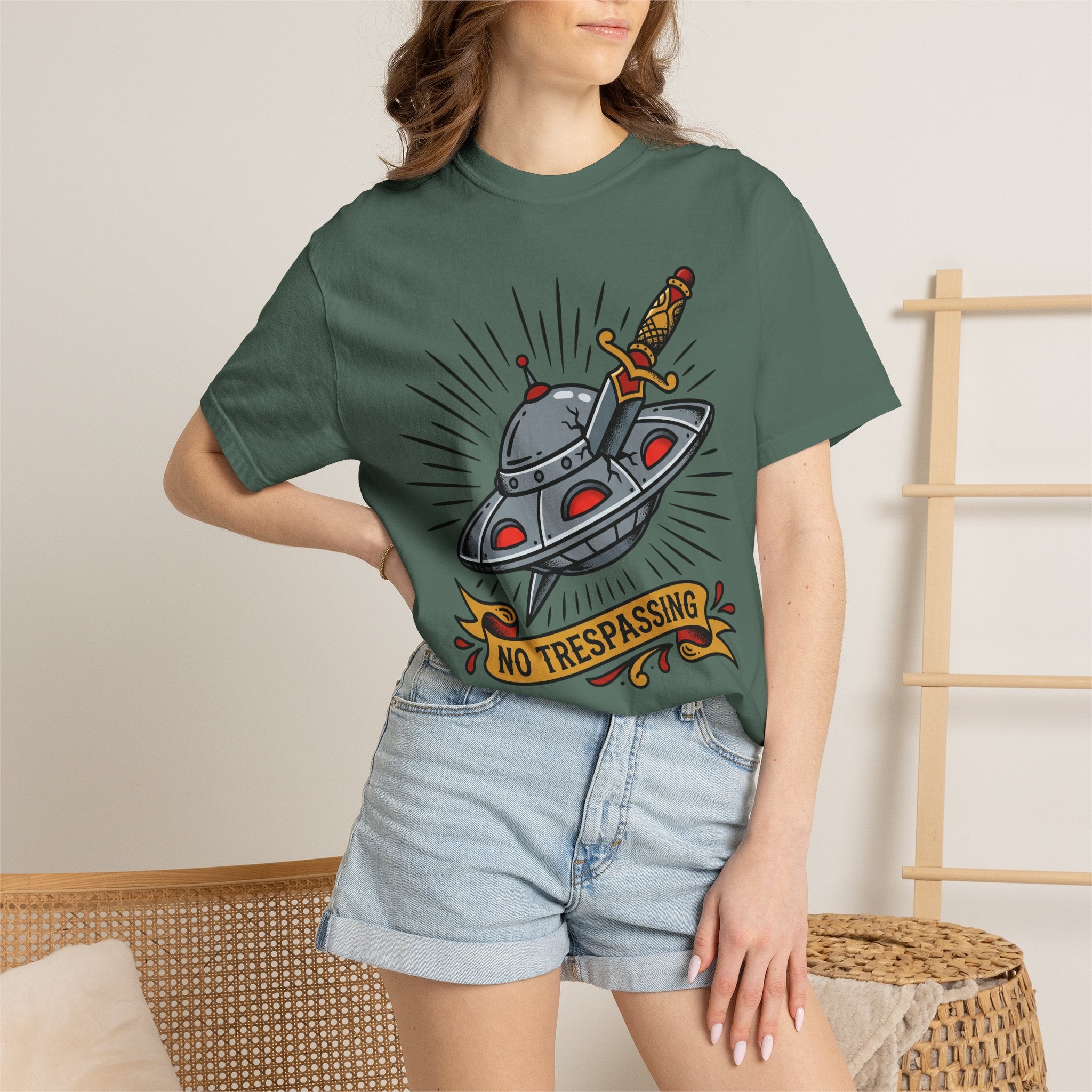 Dark green T-shirt with UFO and dagger graphic and “No Trespassing” text