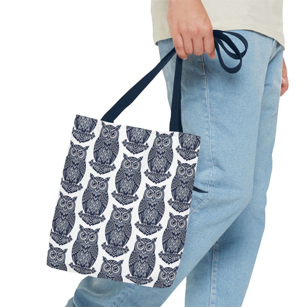 Tote bag with navy handles and repeating navy owl pattern, partial view