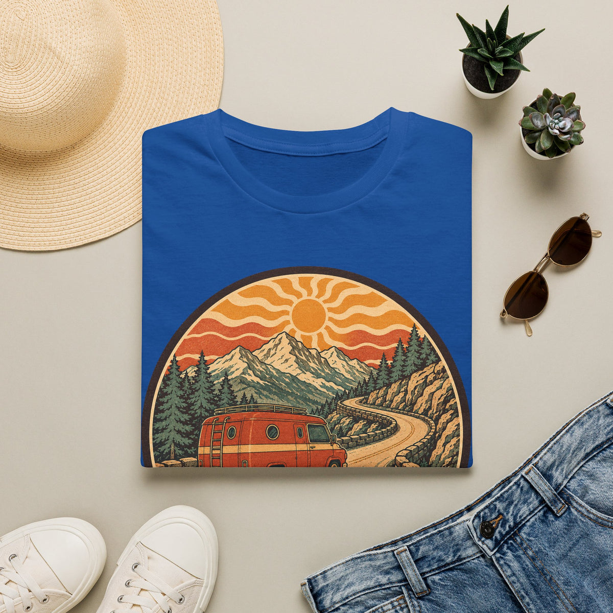 Unisex T-shirt in royal blue with crew neck and mountain sunset van graphic on front.