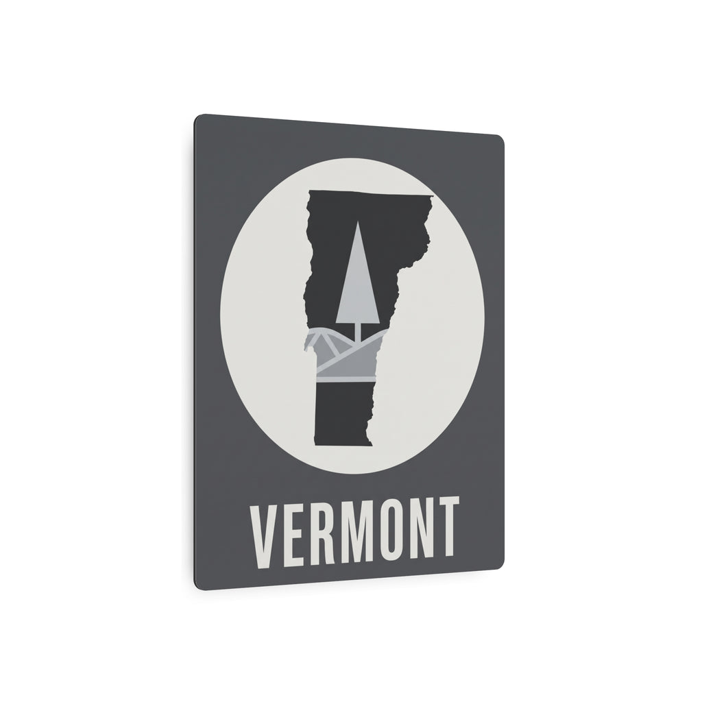 Front of Vermont metal wall sign: circular pine-tree silhouette on dark gray, “VERMONT”.
