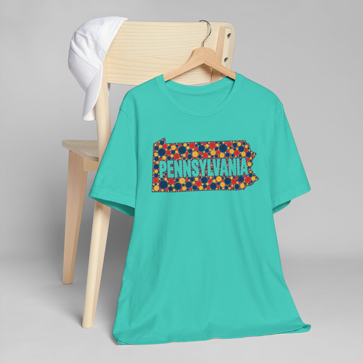Teal short-sleeve T-shirt with colorful floral Pennsylvania word graphic