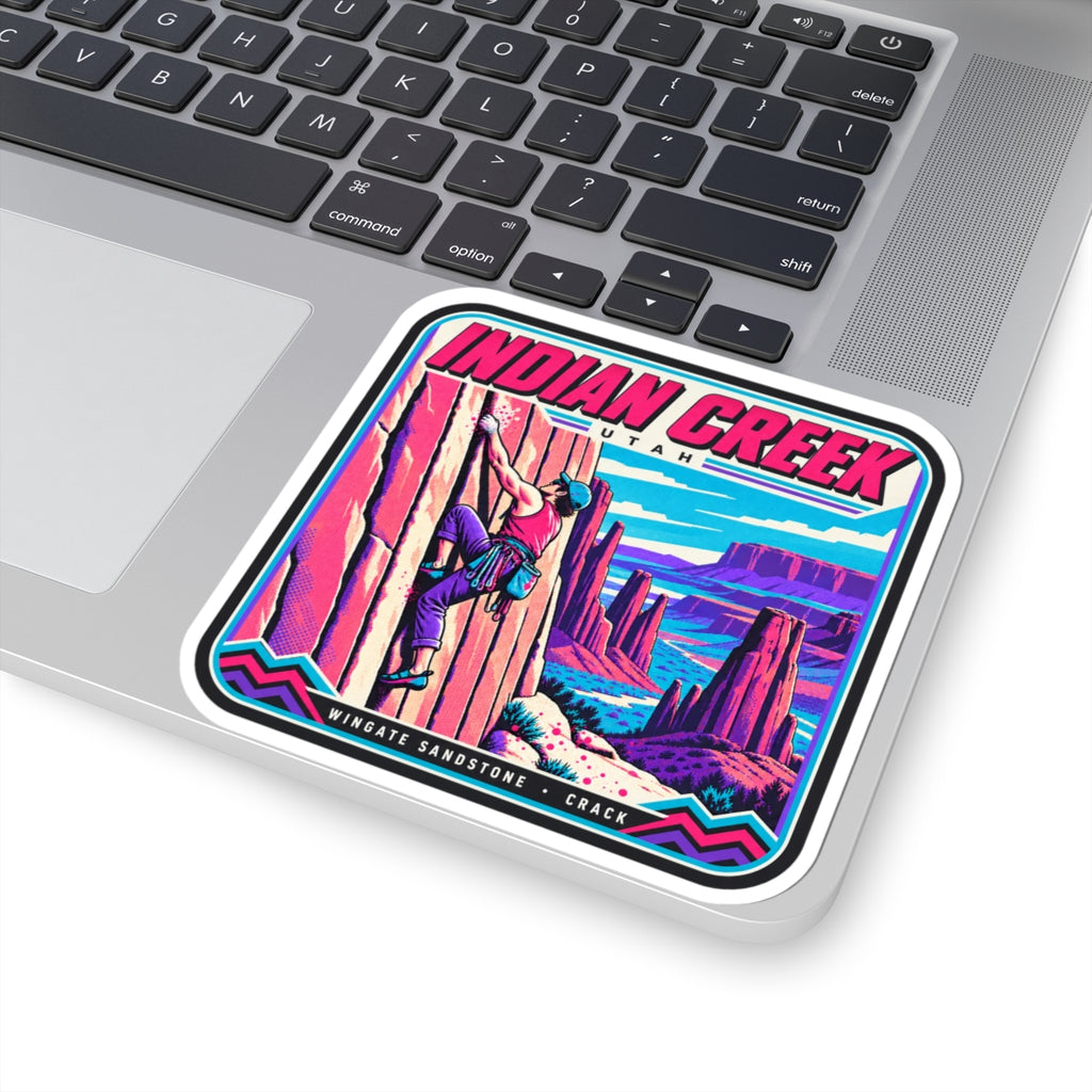 Square “INDIAN CREEK” sticker on laptop trackpad showing climber and canyon scene