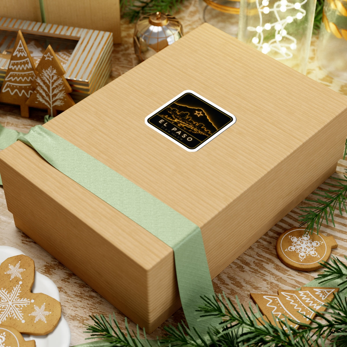 Neon El Paso skyline square sticker on wrapped gift box with pine greenery
