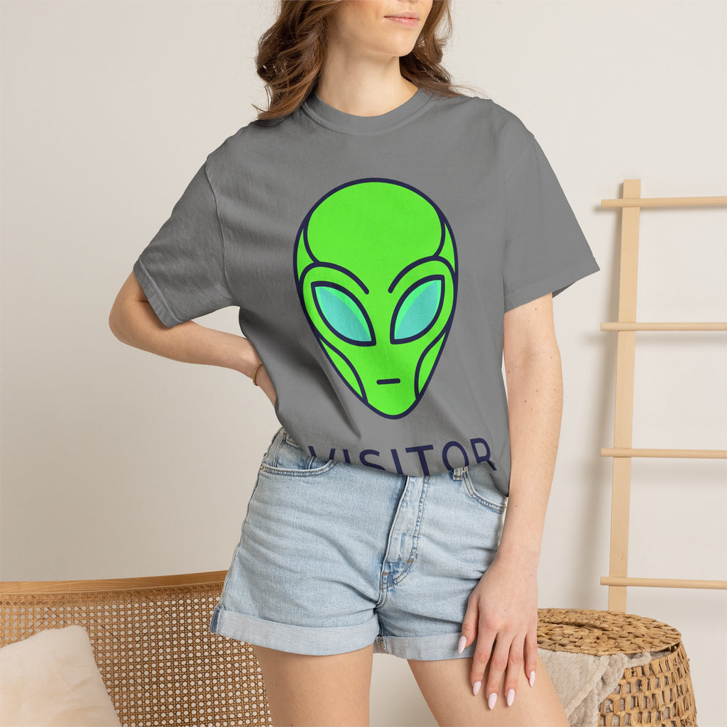 Alien face graphic T-shirt in dark gray with neon green and blue print, worn