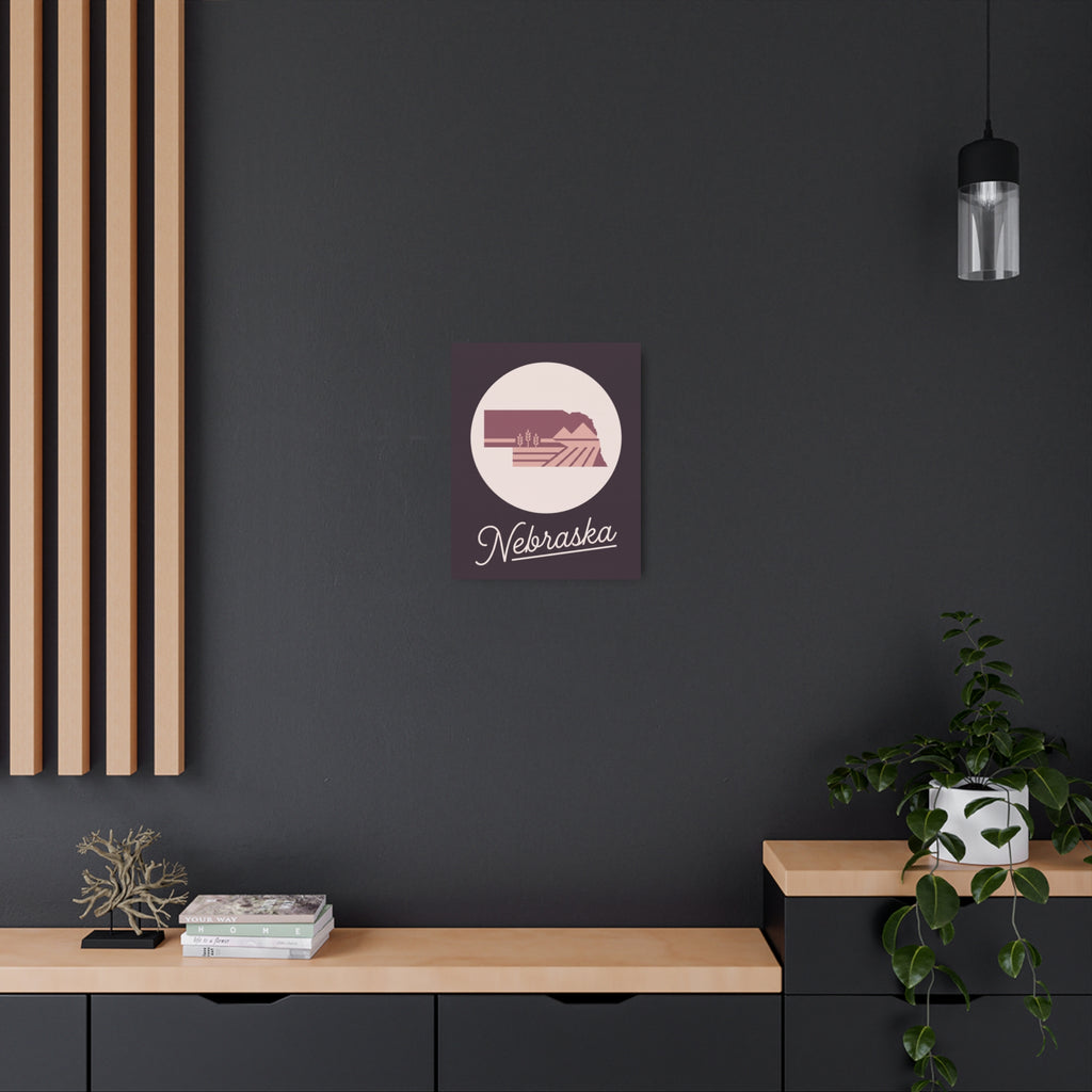 Mauve metal Nebraska wall art with circular emblem and cursive 'Nebraska' text.
