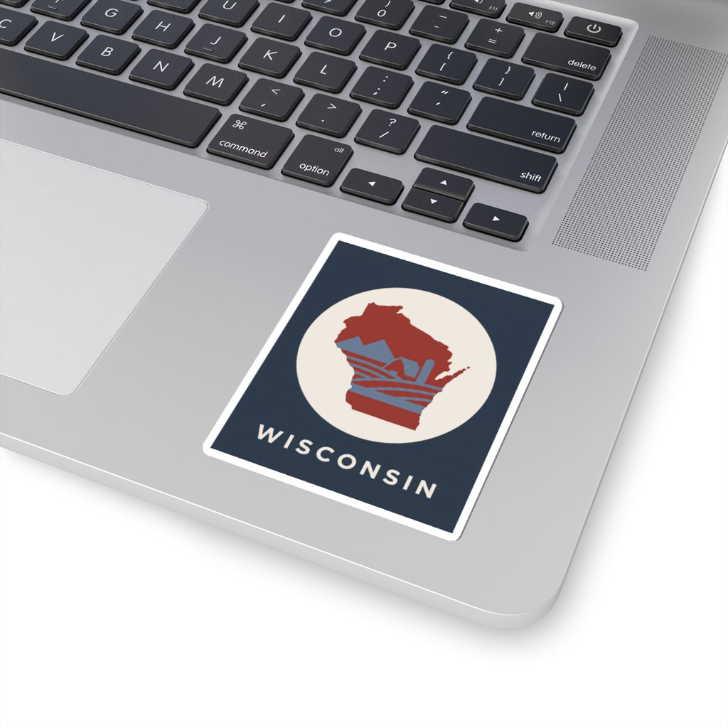 Wisconsin badge sticker on laptop: red Wisconsin map in cream circle with WISCONSIN text