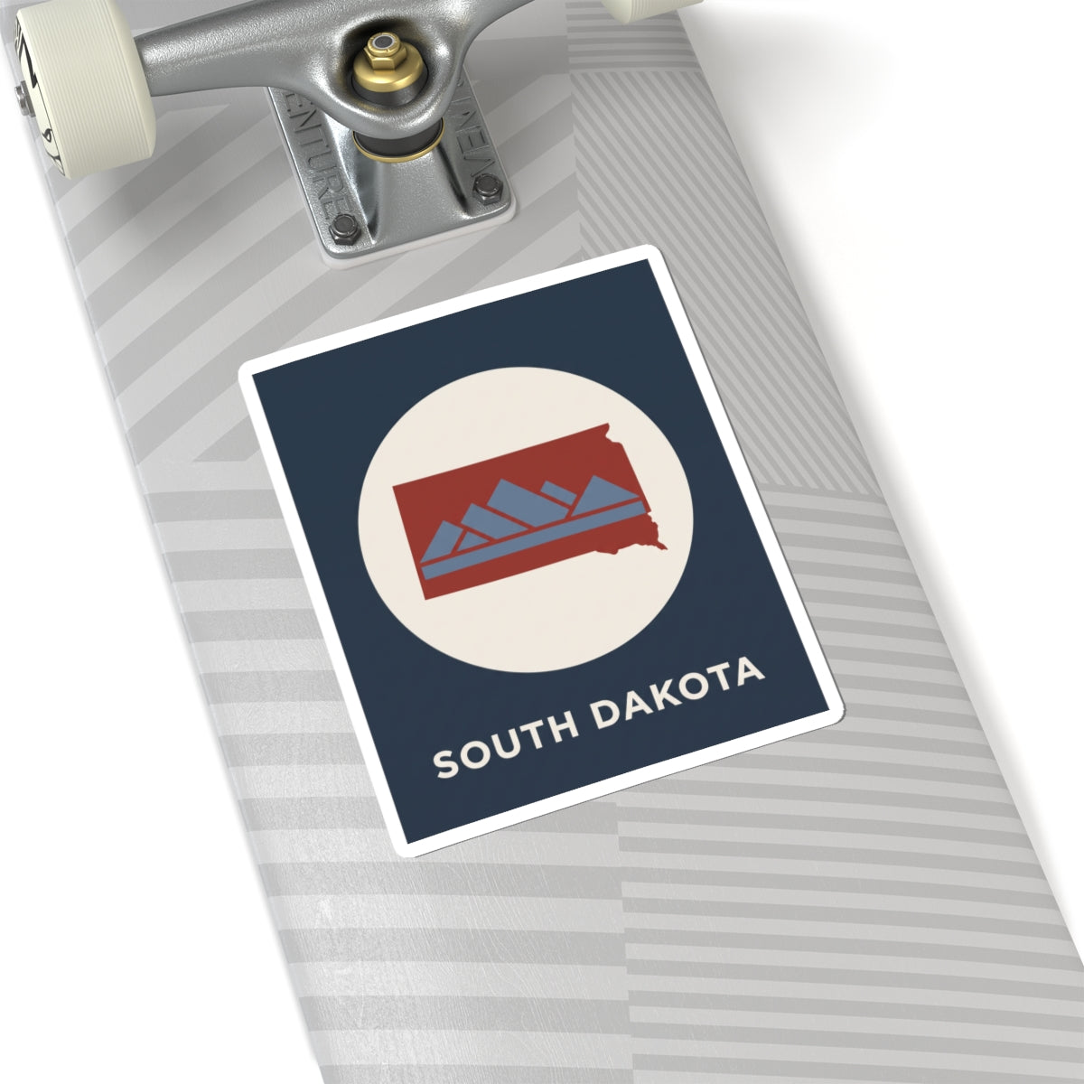 South Dakota map badge sticker on gray striped surface with navy square and red state graphic