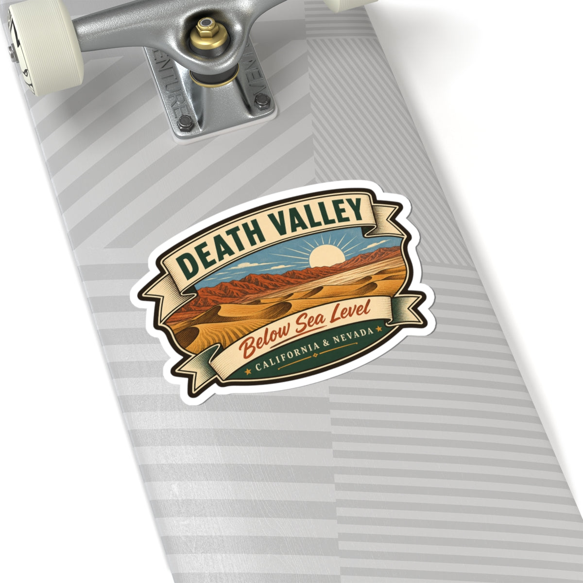 Die-cut sticker on striped surface featuring desert scene, “Death Valley” and “Below Sea Level”