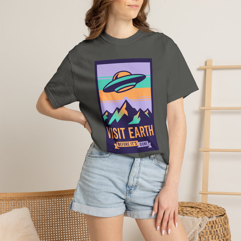 Dark gray T-shirt on model with 'Visit Earth' UFO poster graphic