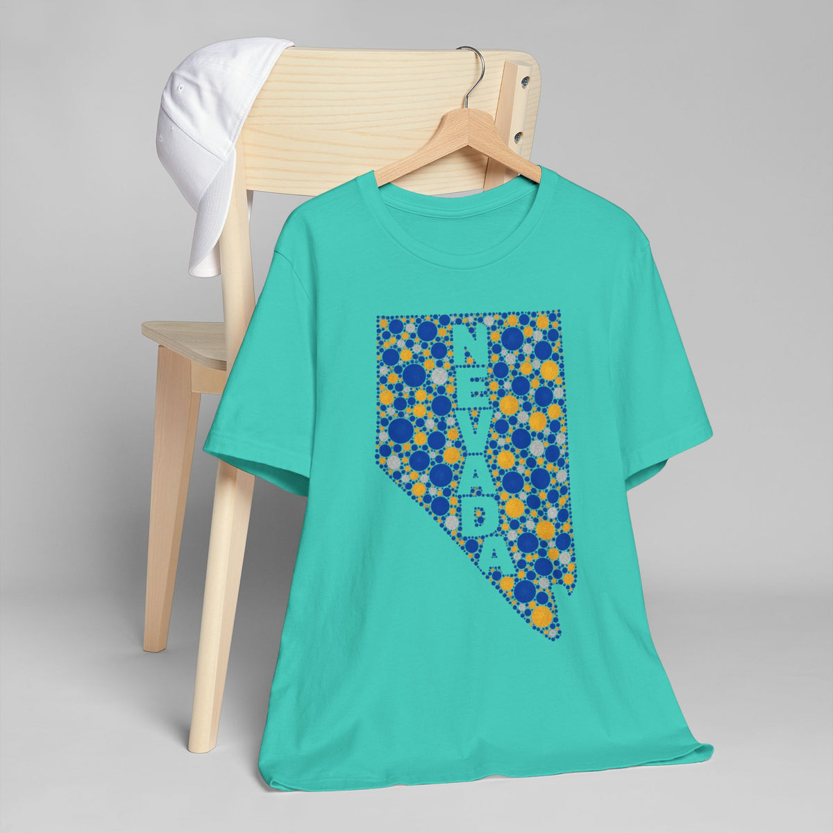 Teal crewneck T-shirt with Nevada state floral dot graphic in blue and gold