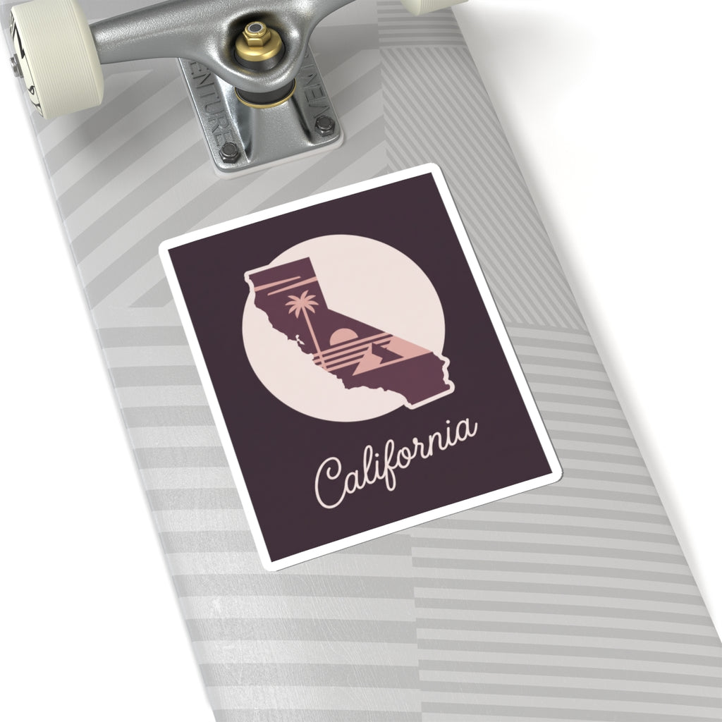 California decal sticker on a suitcase, mauve state silhouette with “California” script