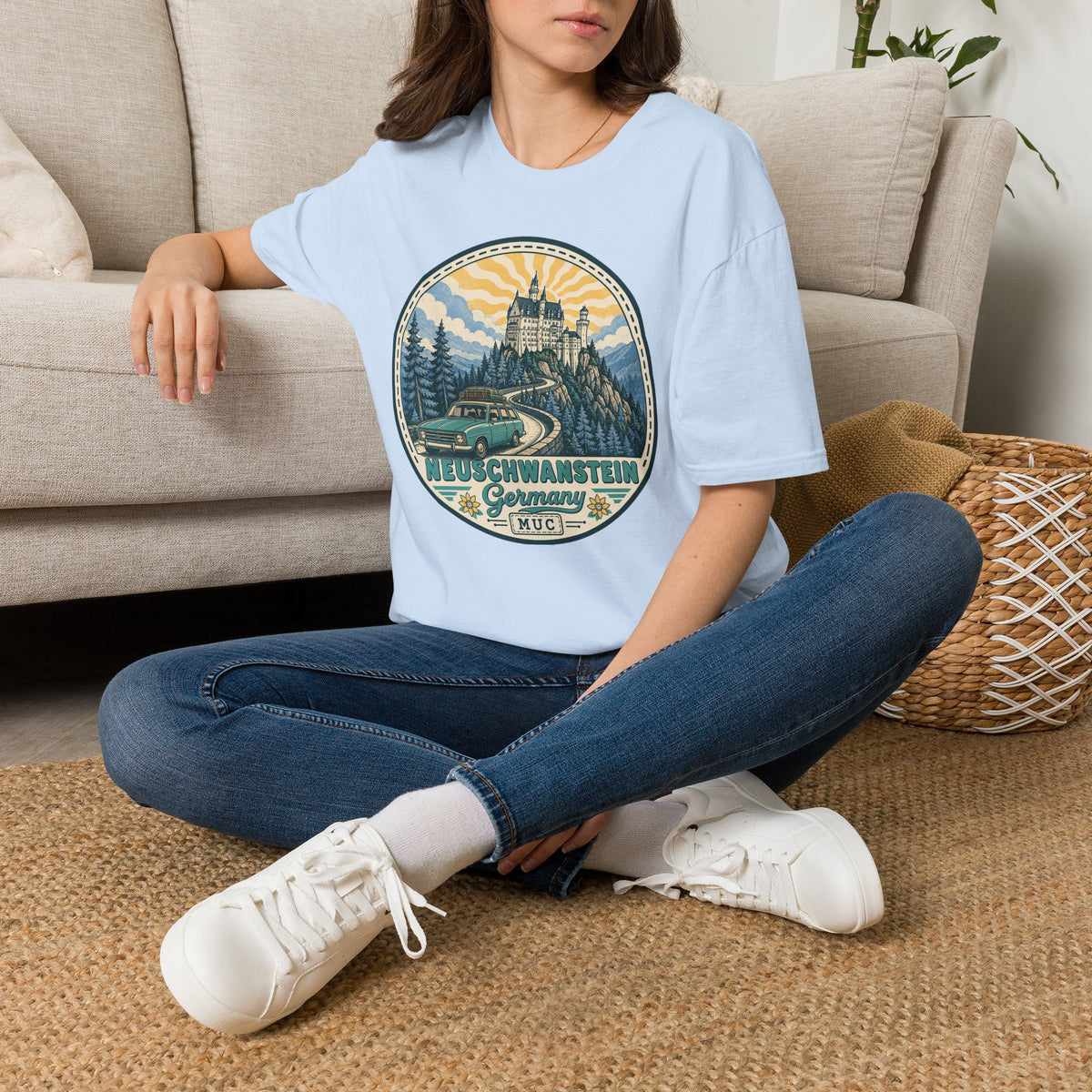 Light blue T-shirt with round Neuschwanstein castle illustration graphic on the chest