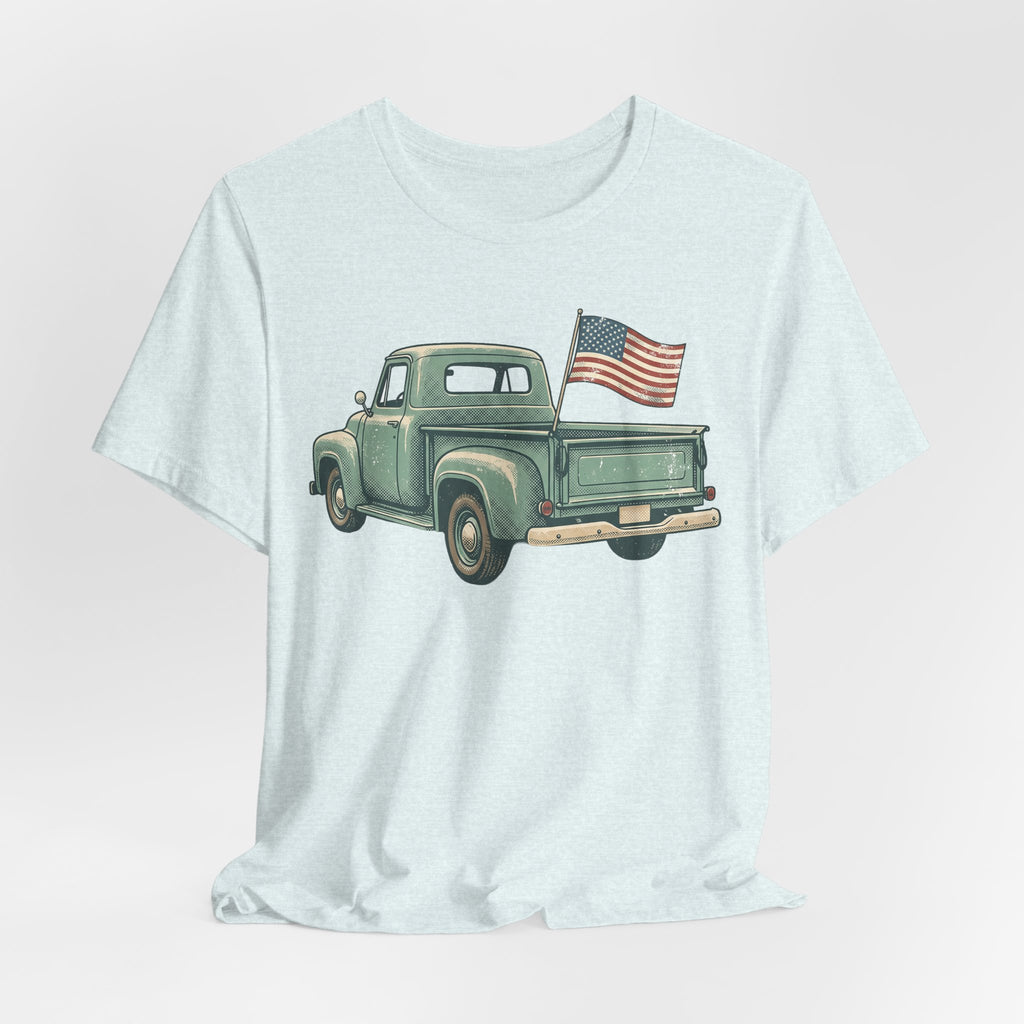 Light blue crewneck t-shirt with green pickup truck and American flag on chest