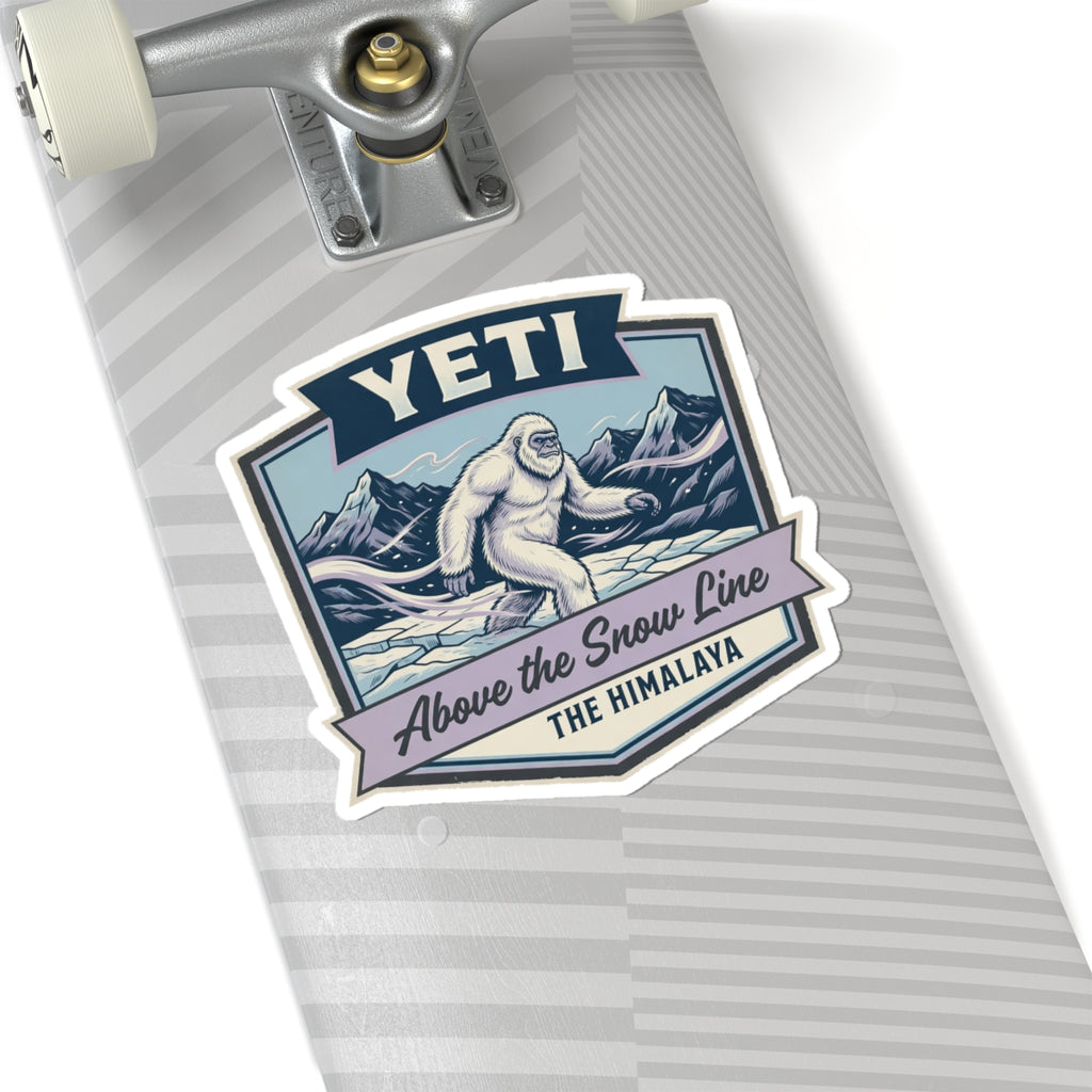 YETI die-cut sticker on striped suitcase tag, Himalayan sasquatch above the snow line