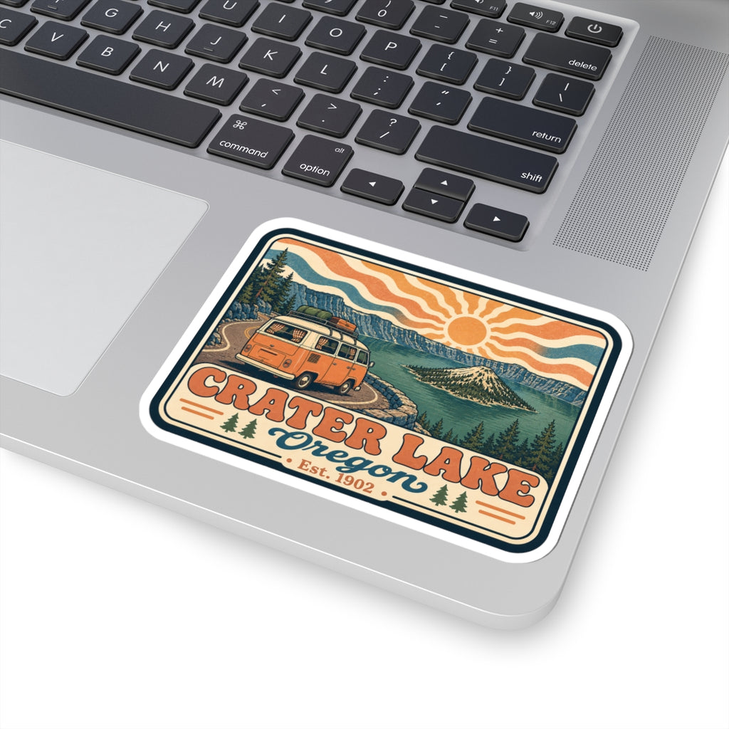 Kiss-cut sticker on laptop, retro Crater Lake Oregon camper van with mountain lake scene
